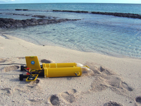 Yellow submarine on a beach.