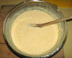 A mixing bowl filled with brown, goopy batter.