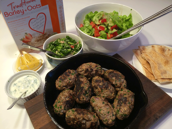 Lamb kibbeh with yoghurt, salad, tabbouleh, and lebanese bread.