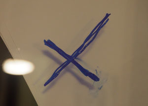 A cross drawn on a window.