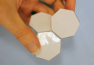 Someone has sticky-taped heptagons to two sides of another heptagon.