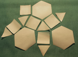 Hexagons, squares and triangles fitting together to cover an area.