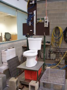 A toilet surrounded by scientific equipment.