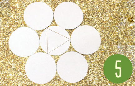 Six circles surround a central circle. A triangle is drawn on the centre circle.