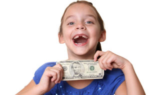 Girl with a missing tooth, holding some money