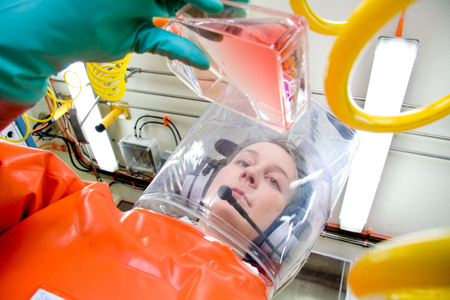 A scientist in an inflatable biohazard suit