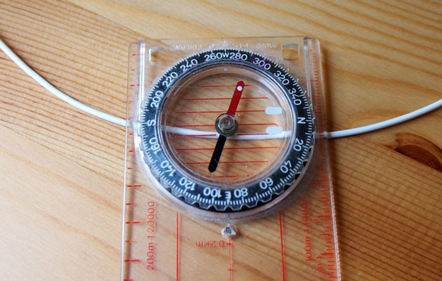 Image of a compass on a piece of wire.