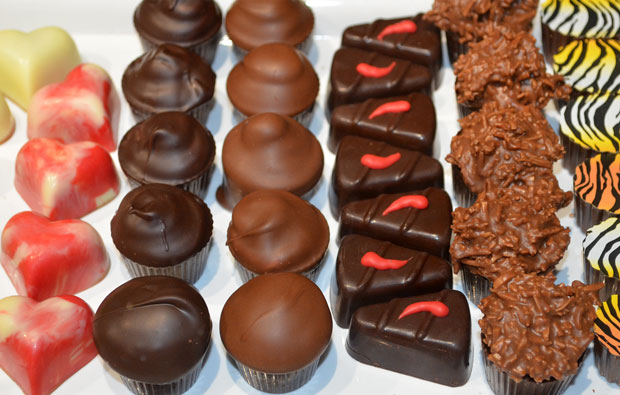 rows of different chocolates, including balls, hearts and tiger striped pieces
