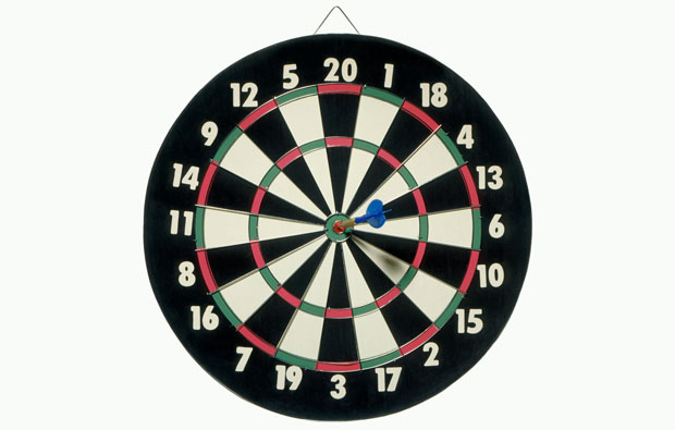 photo of a daart board with a dart in the bullseye position.