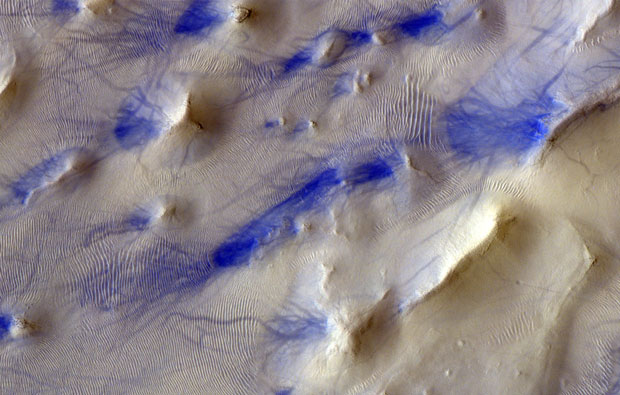 Wispy purple marks on white pitted surface