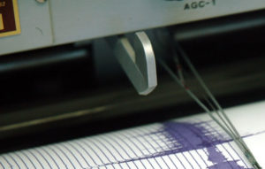 Photo of a seismograph needle recording vibrations