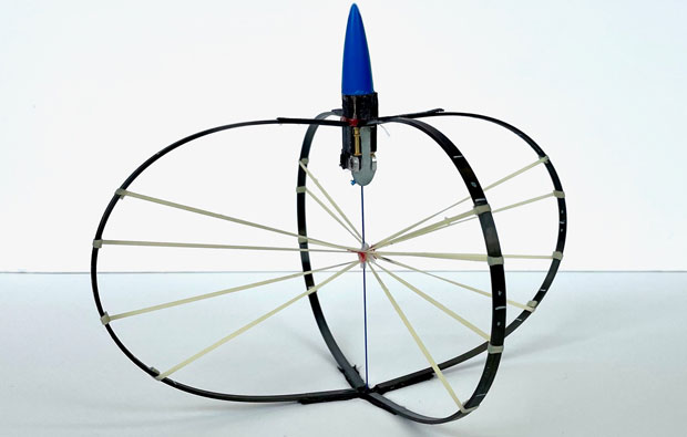 Jumping robot features two intercepting hoops with a small rocket on the top.