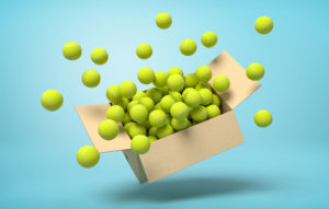 Box bursting open with green balls spilling out.