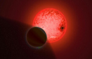 Red star or planet partially shaded by smaller dark star or planet.